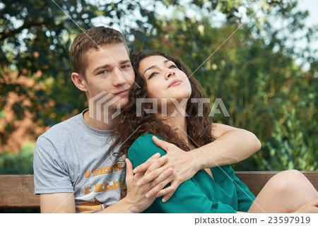 Romantic couple posing in city park, summer season 23597919