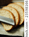 Sliced bread and knife on linen cloth 23598166