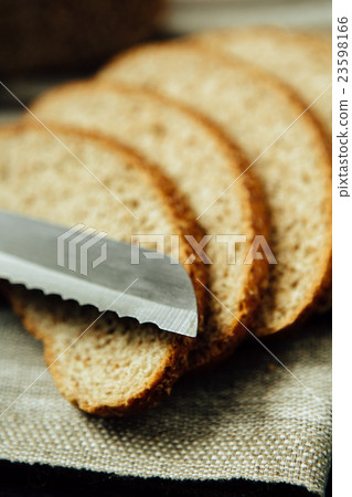 Sliced bread and knife on linen cloth 23598166