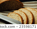 Sliced bread and knife on linen cloth 23598171