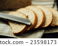 Sliced bread and knife on linen cloth 23598173
