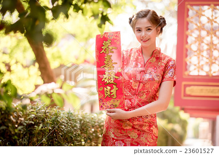 woman in chinese dress holding couplet  23601527