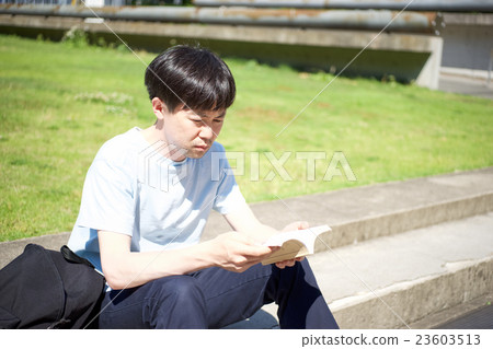 A man sitting at the step and reading A man sitting at the step and reading 23603513