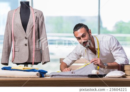 Young tailor working on new clothing design Young tailor working on new clothing design 23604221