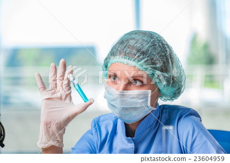 Experienced lab assistant working on chemical 23604959