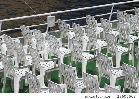many white empty plastic chairs in rows 23606668