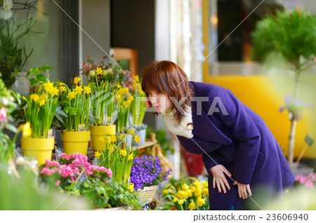 Beautiful woman selecting flowers at flower market 23606940