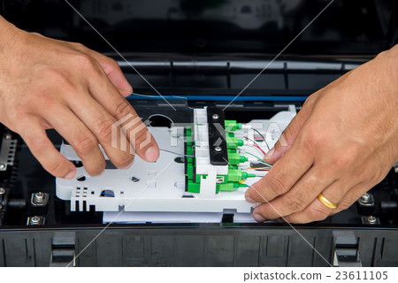 Technicians are installing optic fiber. Technicians are installing optic fiber. 23611105