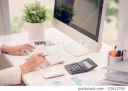 Working on computer Working on computer 23612700