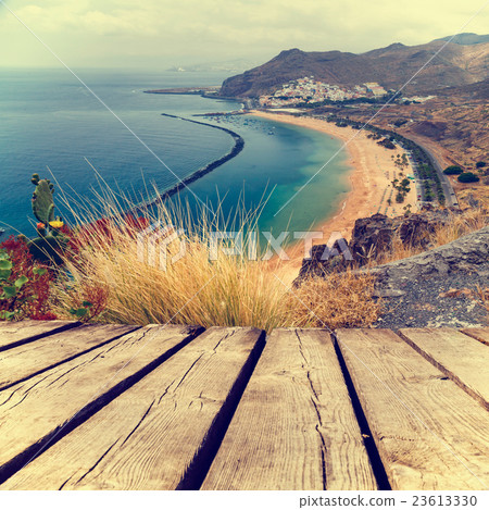 Sunset on the beach and empty wooden deck table Sunset on the beach and empty wooden deck table 23613330