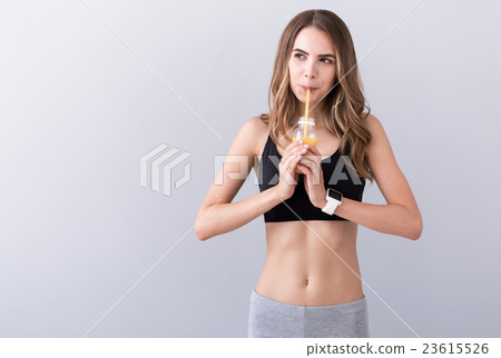 Positive woman drinking juice Positive woman drinking juice 23615526