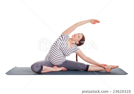 Pregnant woman doing yoga asana Parivrtta janu 23620328