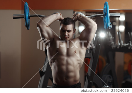 Fitness man exercising with barbell in gym 23624026