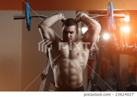 Fitness man exercising with barbell in gym 23624027