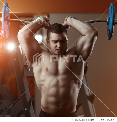 Fitness man exercising with barbell in gym 23624032