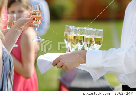 Waiter with dish of champagne glasses Waiter with dish of champagne glasses 23624247