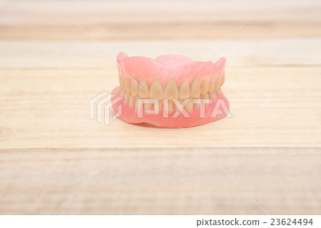 Close-up Dentures on wooden table Close-up Dentures on wooden table 23624494