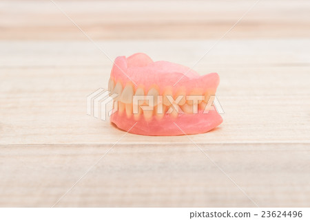 Close-up Dentures on wooden table 23624496