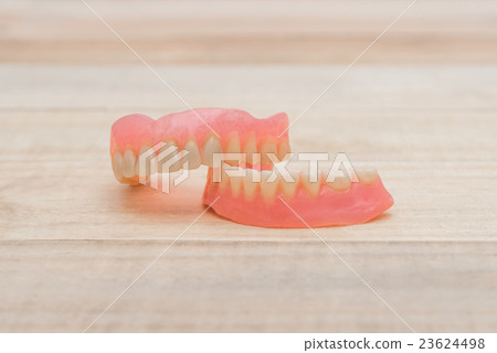 Close-up Dentures on wooden table Close-up Dentures on wooden table 23624498