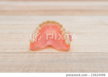 Close-up Dentures on wooden table Close-up Dentures on wooden table 23624499