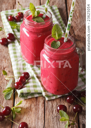 cherry milkshake with a straw in a glass jar cherry milkshake with a straw in a glass jar 23625054