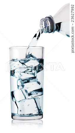 Water being poured into glass from bottle 23627992