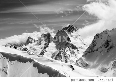 Black and white winter mountains with snow cornice Black and white winter mountains with snow cornice 23628581