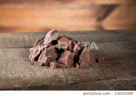 Pieces of milk Chocolate on wood 23630560
