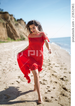 Attractive girl in a smart dress red Attractive girl in a smart dress red 23632961