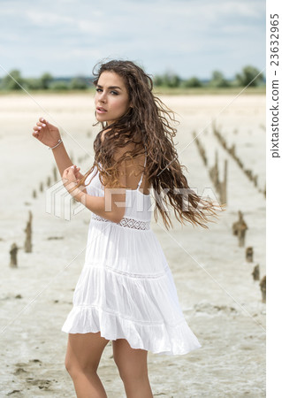 Young girl stands sideways Young girl stands sideways 23632965