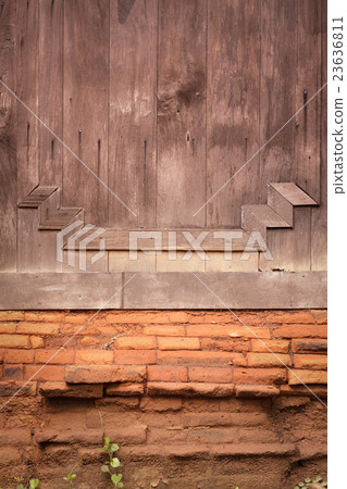 Old wooden wall with old red brick. Old wooden wall with old red brick. 23636811