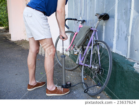 Man's hands pumping cycle wheel Man's hands pumping cycle wheel 23637624