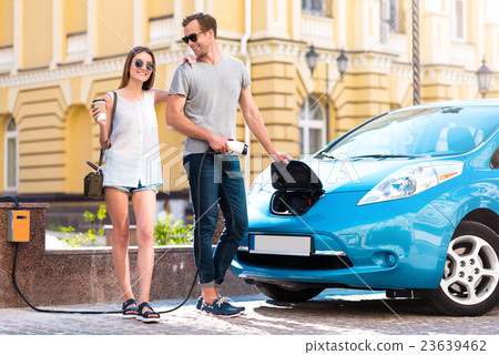 Couple ready to go on electric vehicle Couple ready to go on electric vehicle 23639462