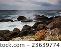 Sunrise over sea  Waves break about coastal stones 23639774