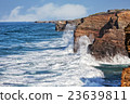 Oceanic waves break about coastal rocks 23639811