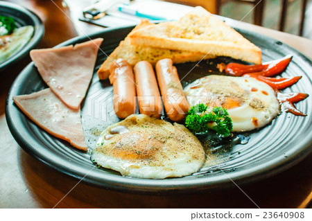 Breakfast with fried eggs, bacon and sausages. Breakfast with fried eggs, bacon and sausages. 23640908