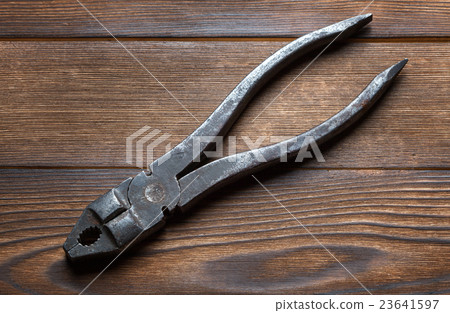 old rusty pliers on wooden background old rusty pliers on wooden background 23641597