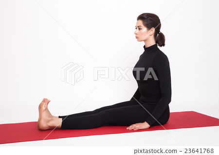 Beautiful athletic girl in black suit doing yoga 23641768