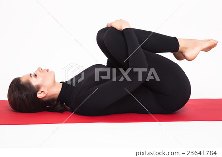Beautiful athletic girl in a black suit doing yoga Beautiful athletic girl in a black suit doing yoga 23641784