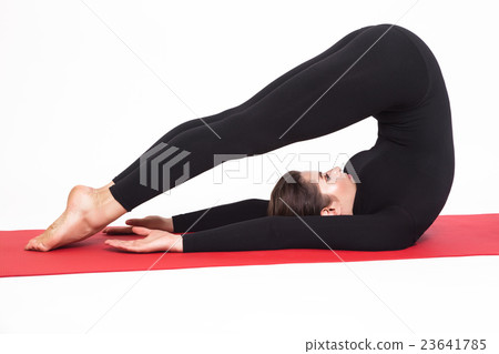 Beautiful athletic girl in black suit doing yoga 23641785