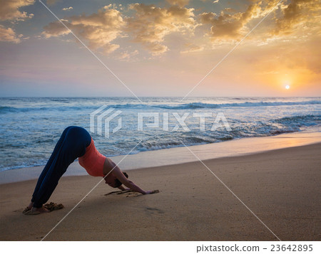 Woman doing yoga Surya Namaskar oudoors at 23642895