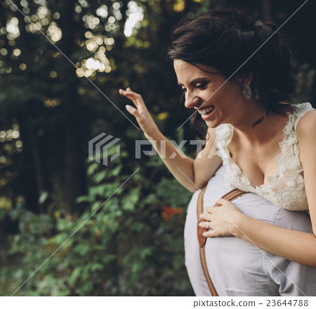 groom holds bride in his arms groom holds bride in his arms 23644788