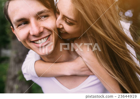 Young adult brunette man and woman in the park Young adult brunette man and woman in the park 23644919