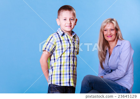 Little boy with mother hold flowers behind back. Little boy with mother hold flowers behind back. 23645129