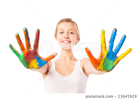 Woman looks out palms painted in colorful paint Woman looks out palms painted in colorful paint 23645929