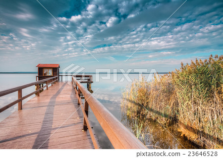 Old wooden pier for fishing, small house shed and Old wooden pier for fishing, small house shed and 23646528