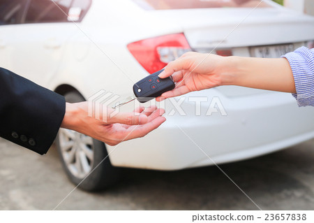 Business hand giving a key for buyer or rental car 23657838