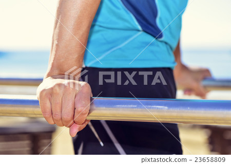 young sportsman doing dips in parallel bars young sportsman doing dips in parallel bars 23658809