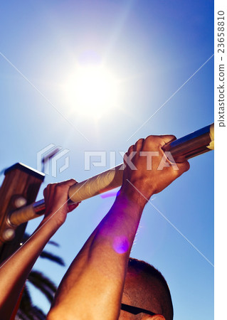 young sportsman doing pull-ups 23658810