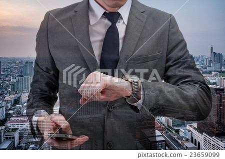 man checking time on wrist watch with cityscape man checking time on wrist watch with cityscape 23659099